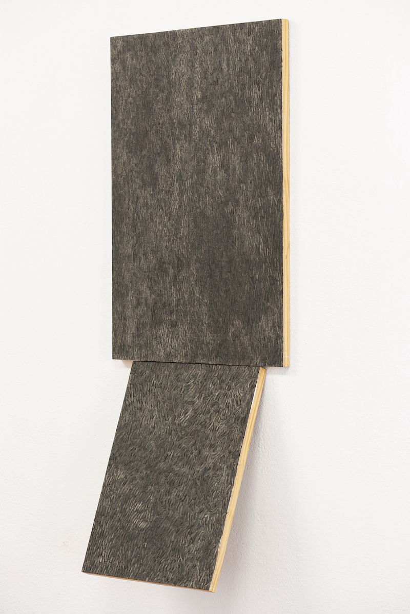 grey scale rectangular paintings on a white wall